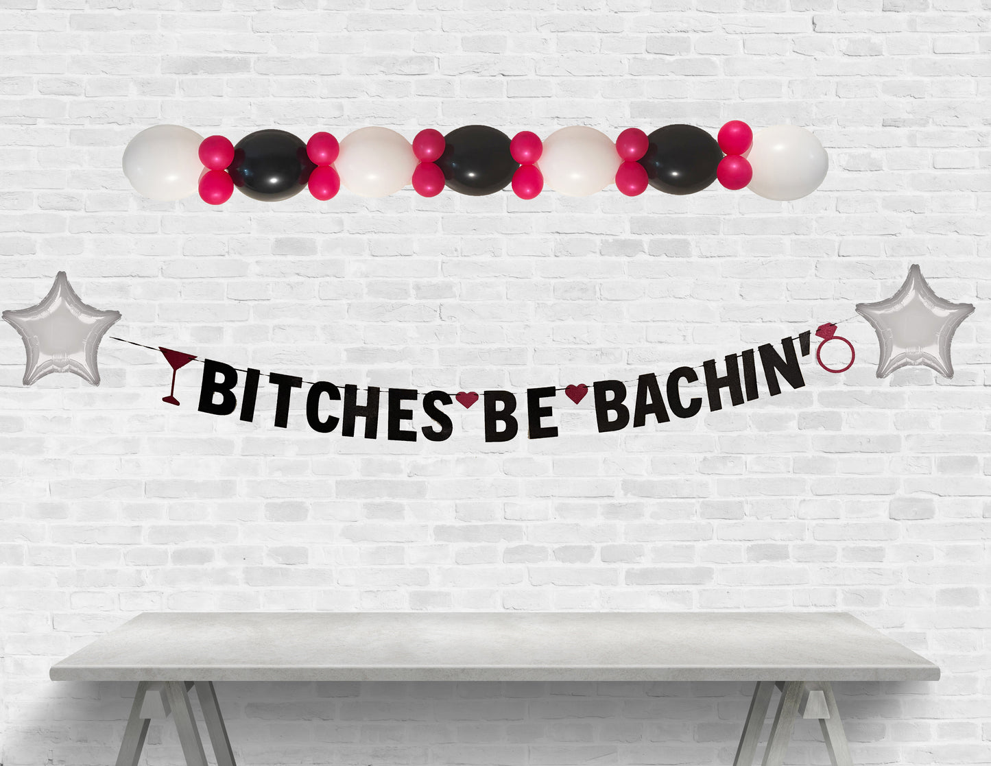 Decorative banner with balloons and text on a white brick wall background