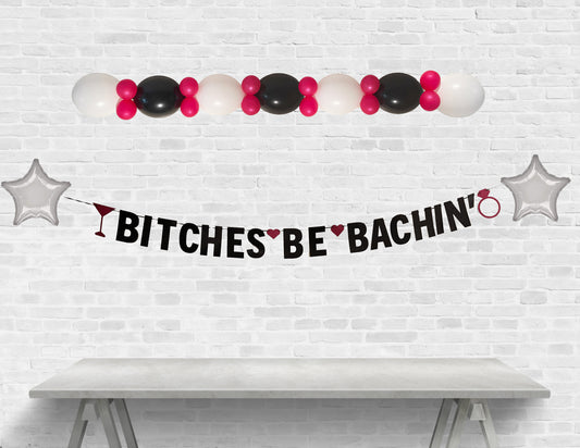 Decorative banner with balloons and text on a white brick wall background