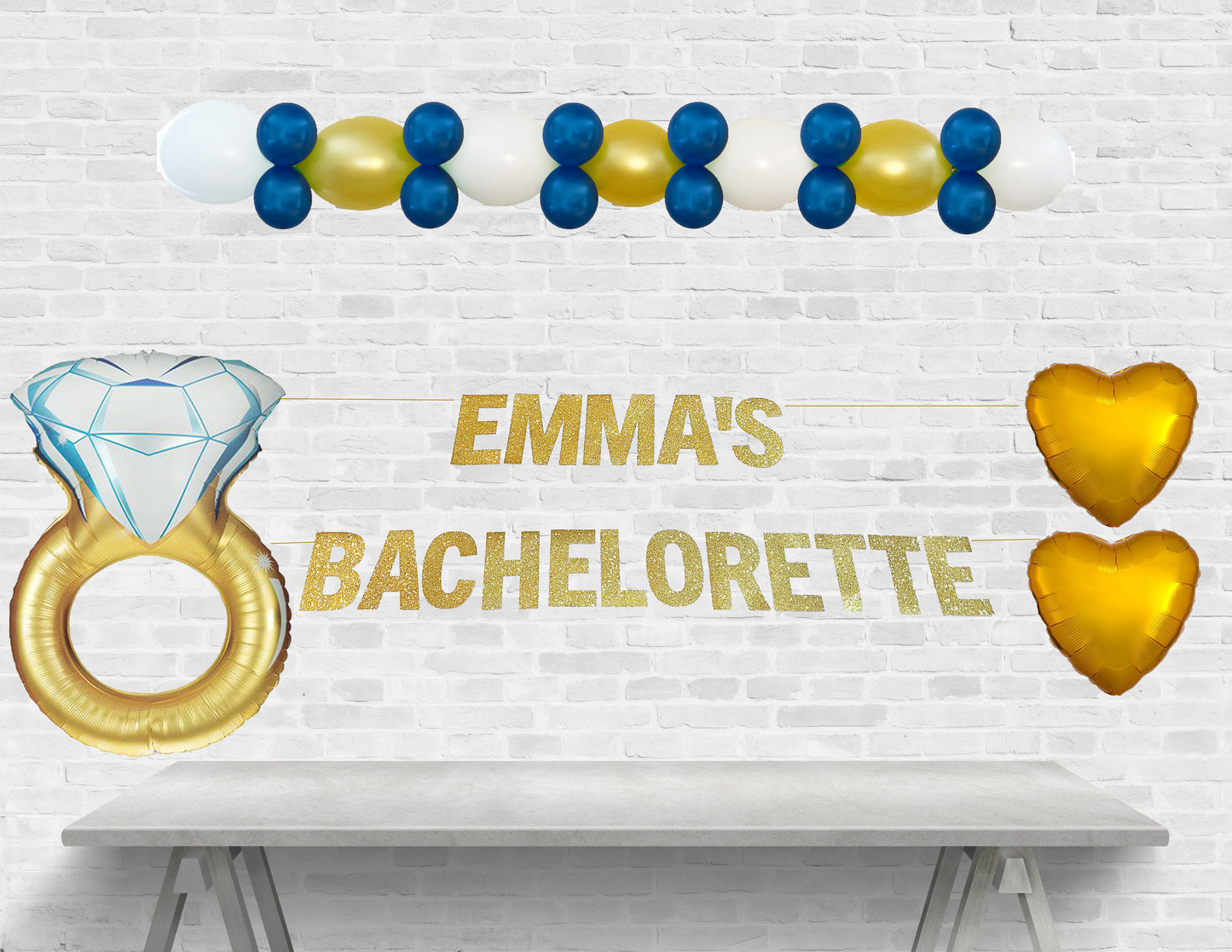 Decorative setup for Emma's bachelorette party with balloons and text on a white brick wall.