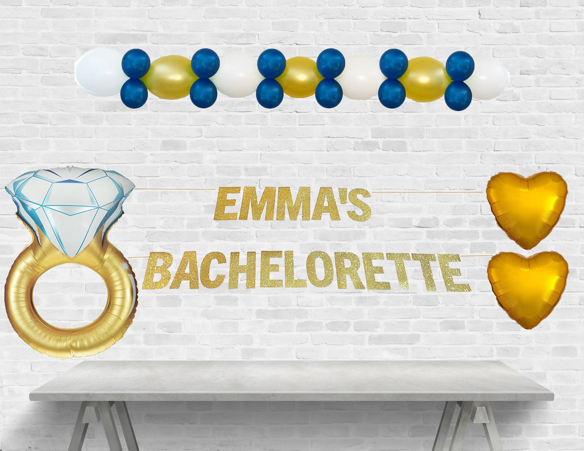 Decorative setup for Emma's bachelorette party with balloons and text on a white brick wall.